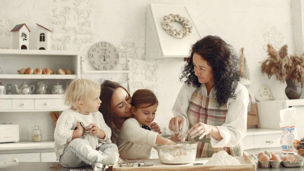 Three generations baking together in a bright kitchen, showcasing love and tradition.