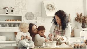 Three generations baking together in a bright kitchen, showcasing love and tradition.