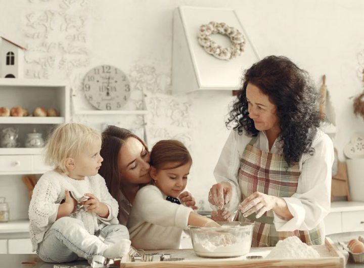 Three generations baking together in a bright kitchen, showcasing love and tradition.